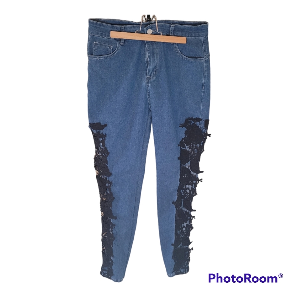 Denim blue jeans with black embroidery lace down the sides. Size Medium.